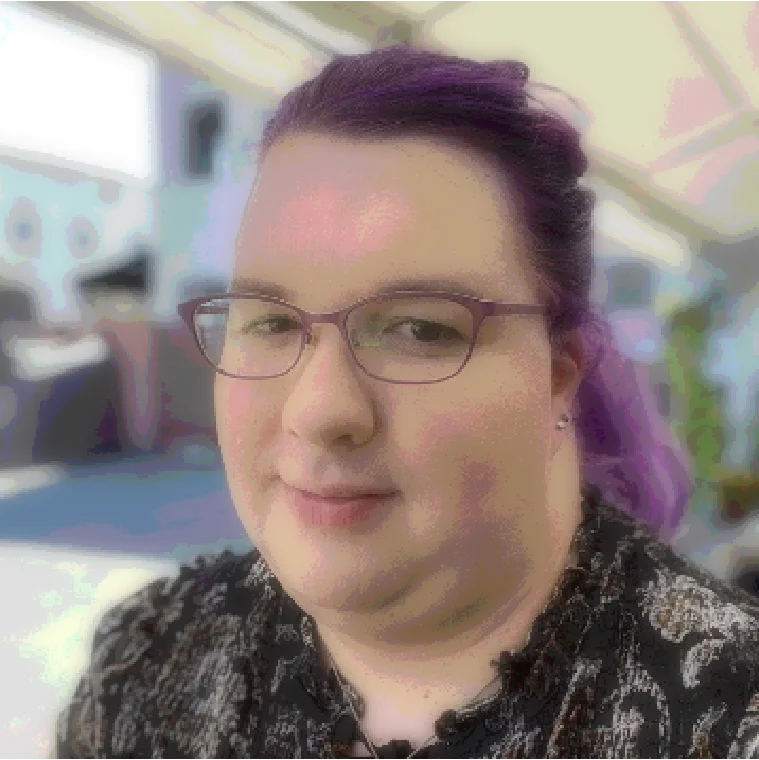 A picture of Kiley, slightly pixelated and bit-crushed, but still smiling and with her trademark purple hair.